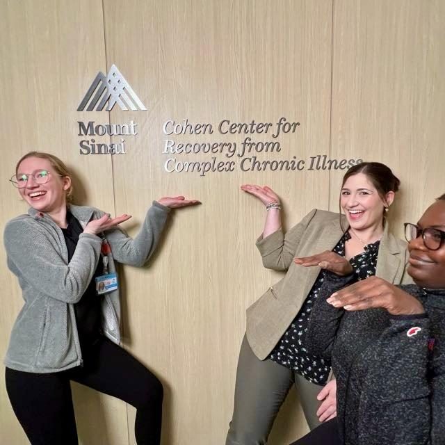 Val and colleagues posing by the Cohen Center for Recovery from Complex Chronic Illness sign at Mount Sinai