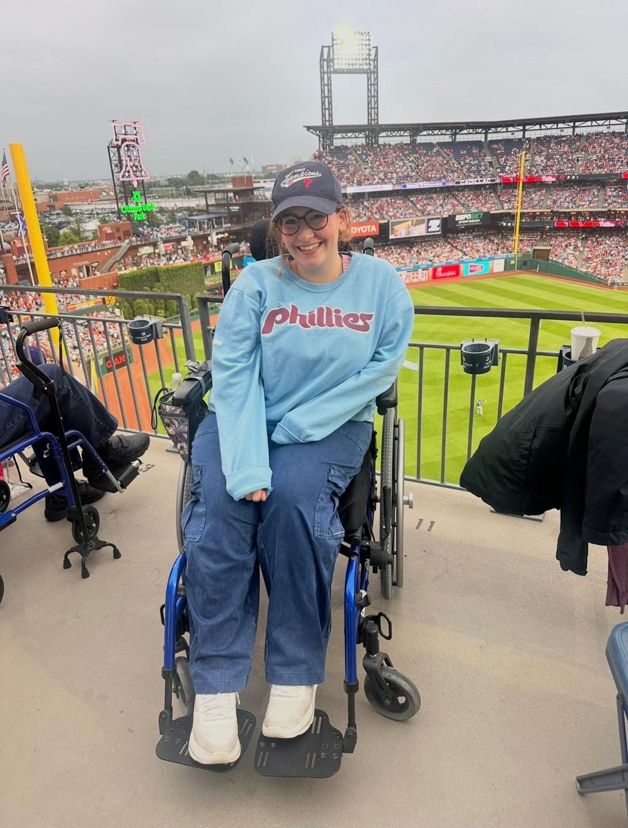Val in her wheelchair at a Phillies game, wearing a Phillies sweatshirt