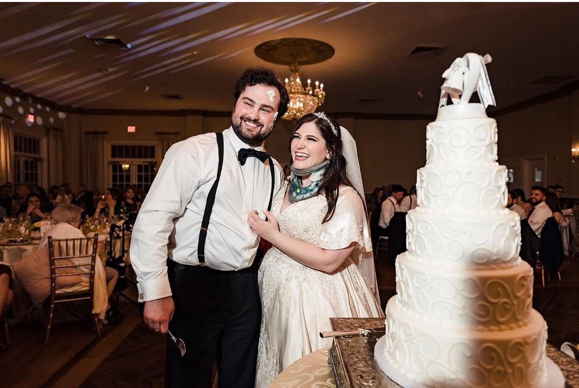 Val and Joe cutting their wedding cake