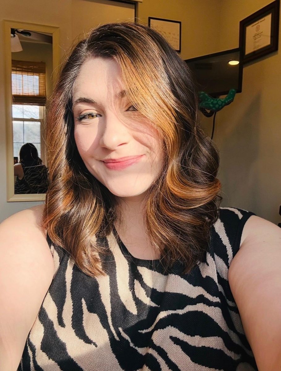 Val smiling in a zebra-print top
